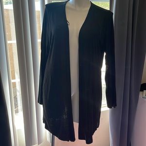 Black jacket with back pleated detail.